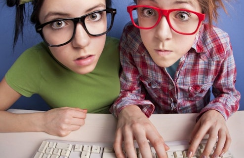 Two girls with glasses at computer