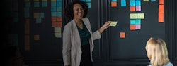 Woman with post it notes on a board