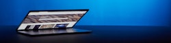Laptop computer in front of blue background