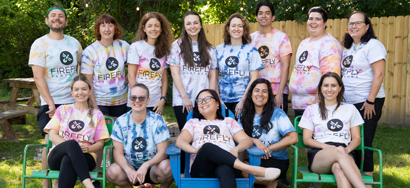 Firefly team group photo in tie dye shirts
