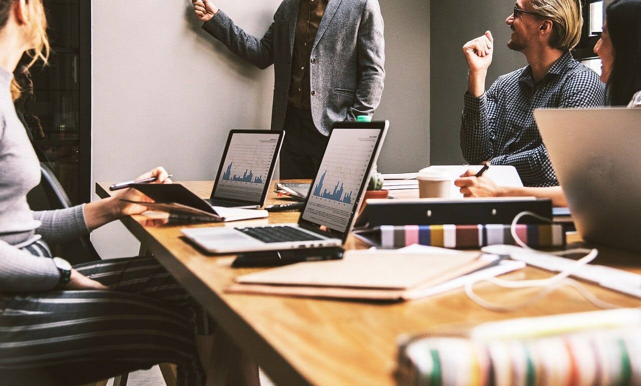 People at a meeting around a conference room table.